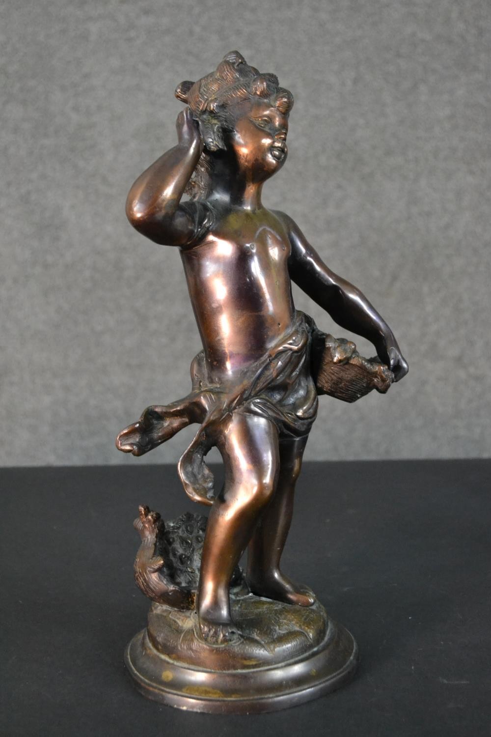 A spelter figure of a classical style putti with a basket of flowers. H.37cm - Image 4 of 8