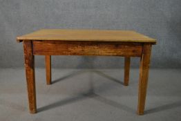 A 19th century pine kitchen table, with a later rectangular top, over an end drawer, on square