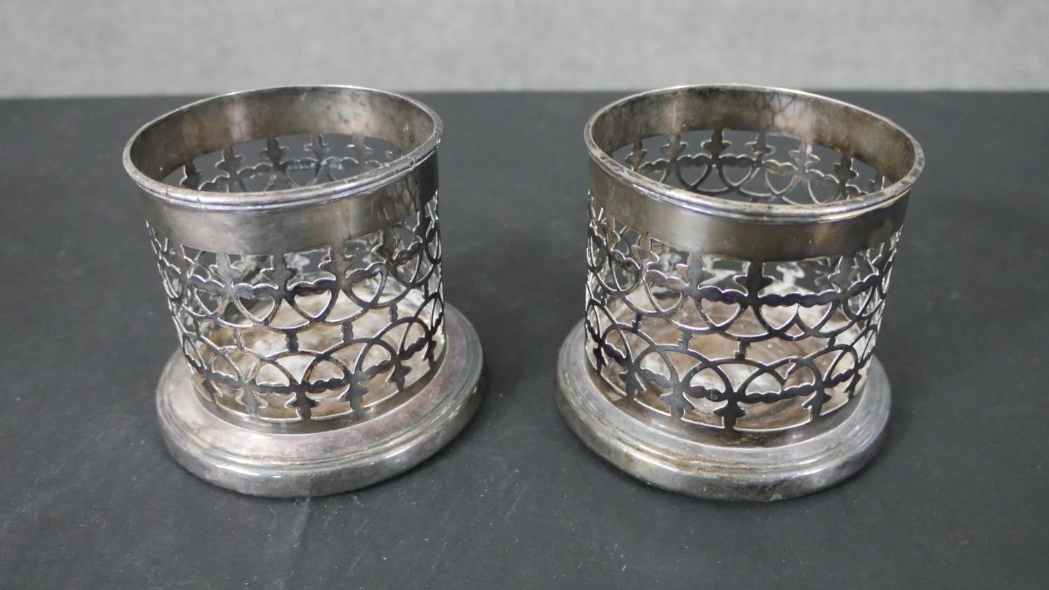 A pair of silver plated pierced design wine coasters and a similar twin handled bottle holder. H. - Image 6 of 7