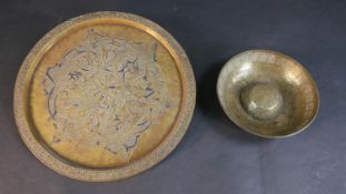 A Persian 19th century engraved tray along with a doughnut shaped bowl, both with calligraphic