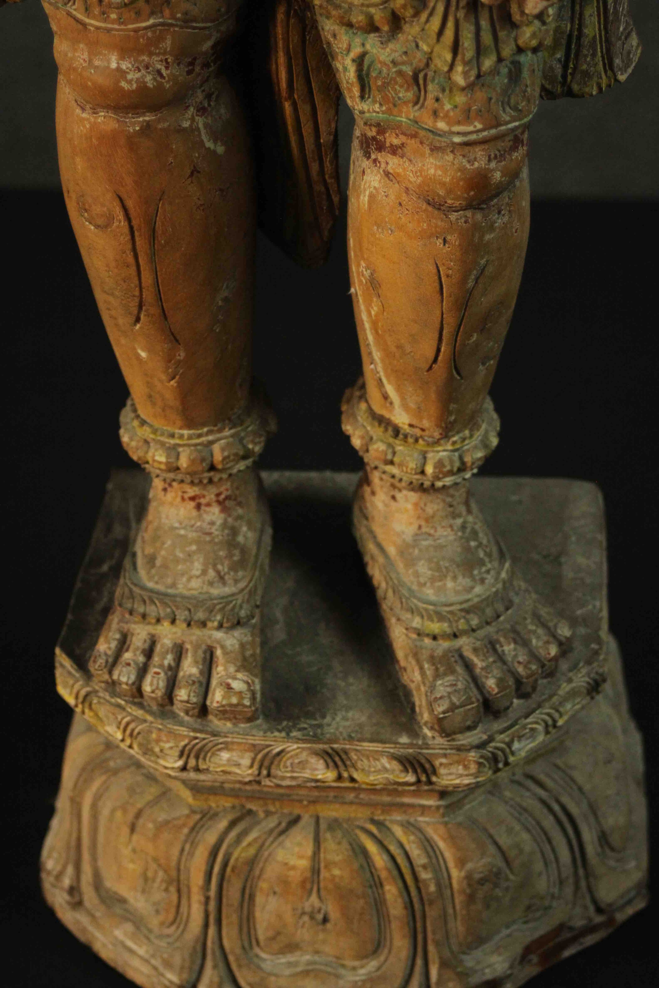 A large carved and painted 19th century Oriental statue of a deity standing on a lotus form base. - Image 5 of 10