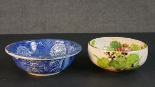 Two Japanese hand painted ceramic bowls. One blue and white stylised floral design bowl and an