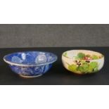 Two Japanese hand painted ceramic bowls. One blue and white stylised floral design bowl and an