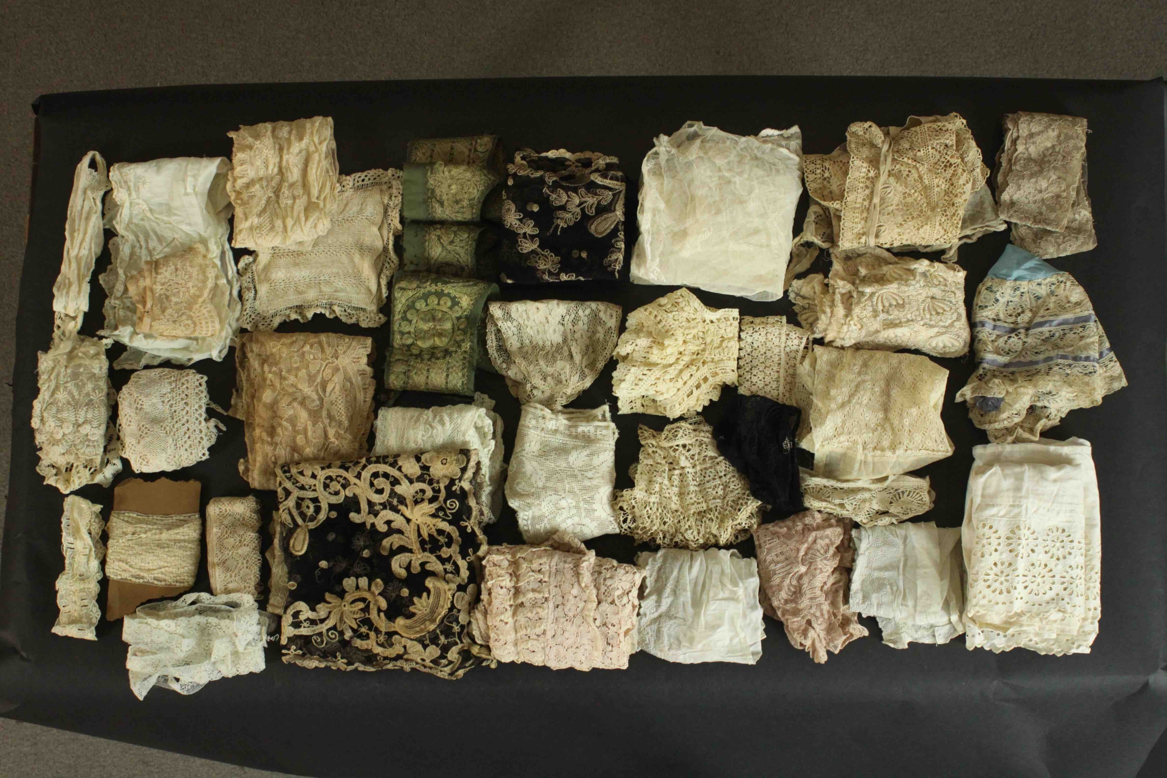 A collection of thirty pieces of 19th century hand embroidered lace.