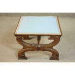 A late 19th century French walnut footstool, of square form upholstered in light blue fabric, on