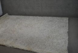 An Indian shag pile carpet. L.300 W.207cm