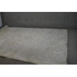 An Indian shag pile carpet. L.300 W.207cm