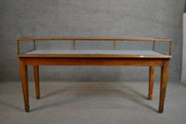 An F. Maund and E. Berg glazed walnut bijouterie display cabinet, on square section tapering legs,