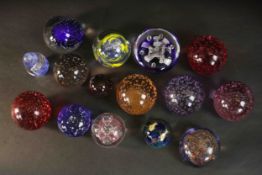 A collection of fifteen art glass paperweights, some with bubble design. H.9 Dia.10cm (largest)