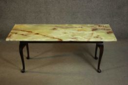 A late 20th century rectangular coffee table, with an onyx top on a fruitwood base with cabriole