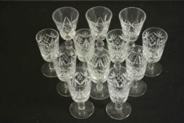 A set of twelve hand cut crystal sherry glasses. H.10cm. (largest)