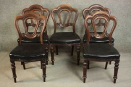 A set of five Victorian mahogany dining chairs, the serpentine seat upholstered in black faux