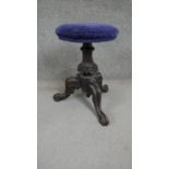 A Victorian mahogany stool, the circular seat upholstered in blue velour on a carved baluster stem