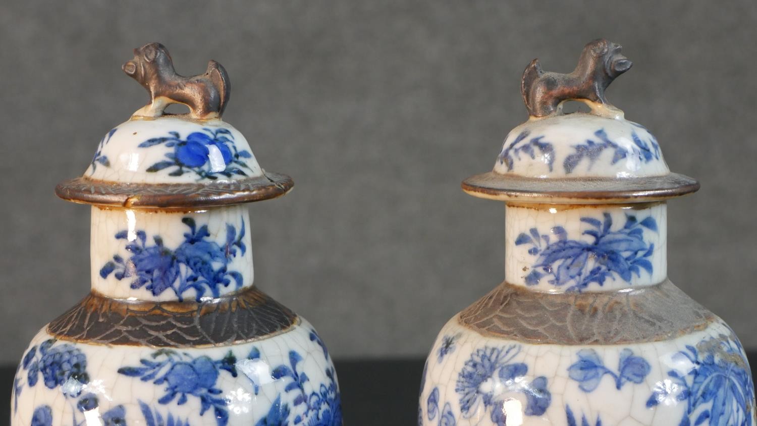 A pair of early 20th century Chinese blue and white crackle glazed vases and covers. The lidded jars - Image 2 of 8