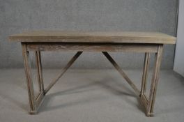 A contemporary limed oak metamorphic console table/dining table with a rectangular foldover top, the