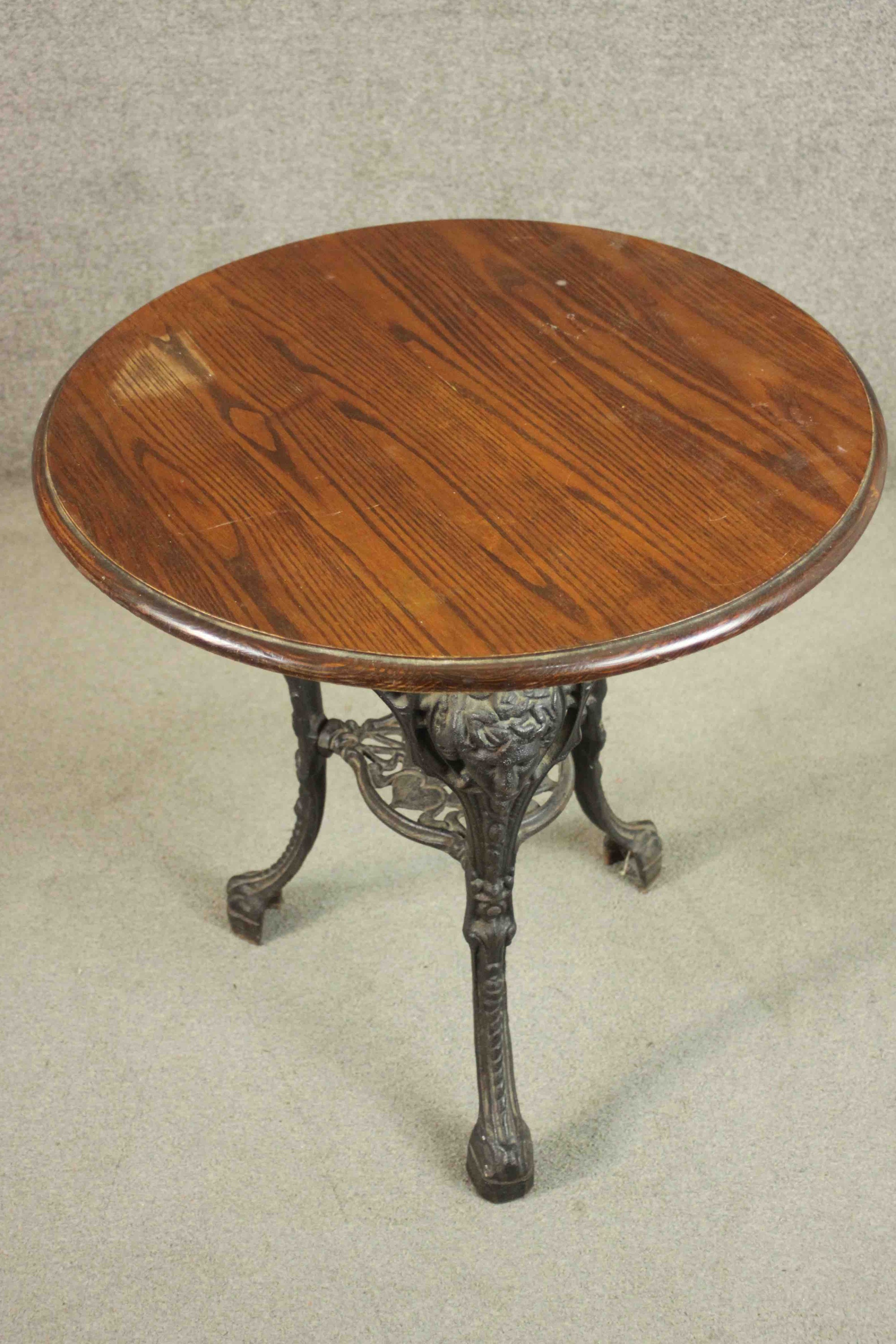 A black painted Victorian cast iron pub table with a circular pitch pine top on three curved legs - Image 3 of 4