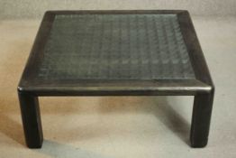 A contemporary ebonised ash coffee table, of square form with a lattice centre. H.35 W.90 D.90cm.