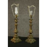 A pair of Continental Rococo Revival brass table lamps, of organic lobed form on a flared quatraform