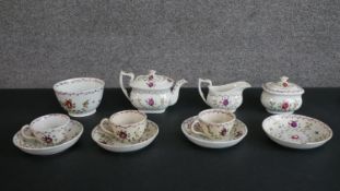 A 19th century floral design hand-painted ceramic dolls tea set for four people (one cup missing),