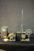 A vintage Super 8 projector and an Aldis 303 colour slide projector with screen. H.135 L.8cm.