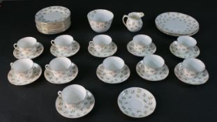 A part twelve person Aynsley hand painted thistle pattern tea set. Includes eleven cups and saucers,