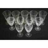 A collection of eleven drinking glasses, including a set of five blown glass hobnail pattern trumpet