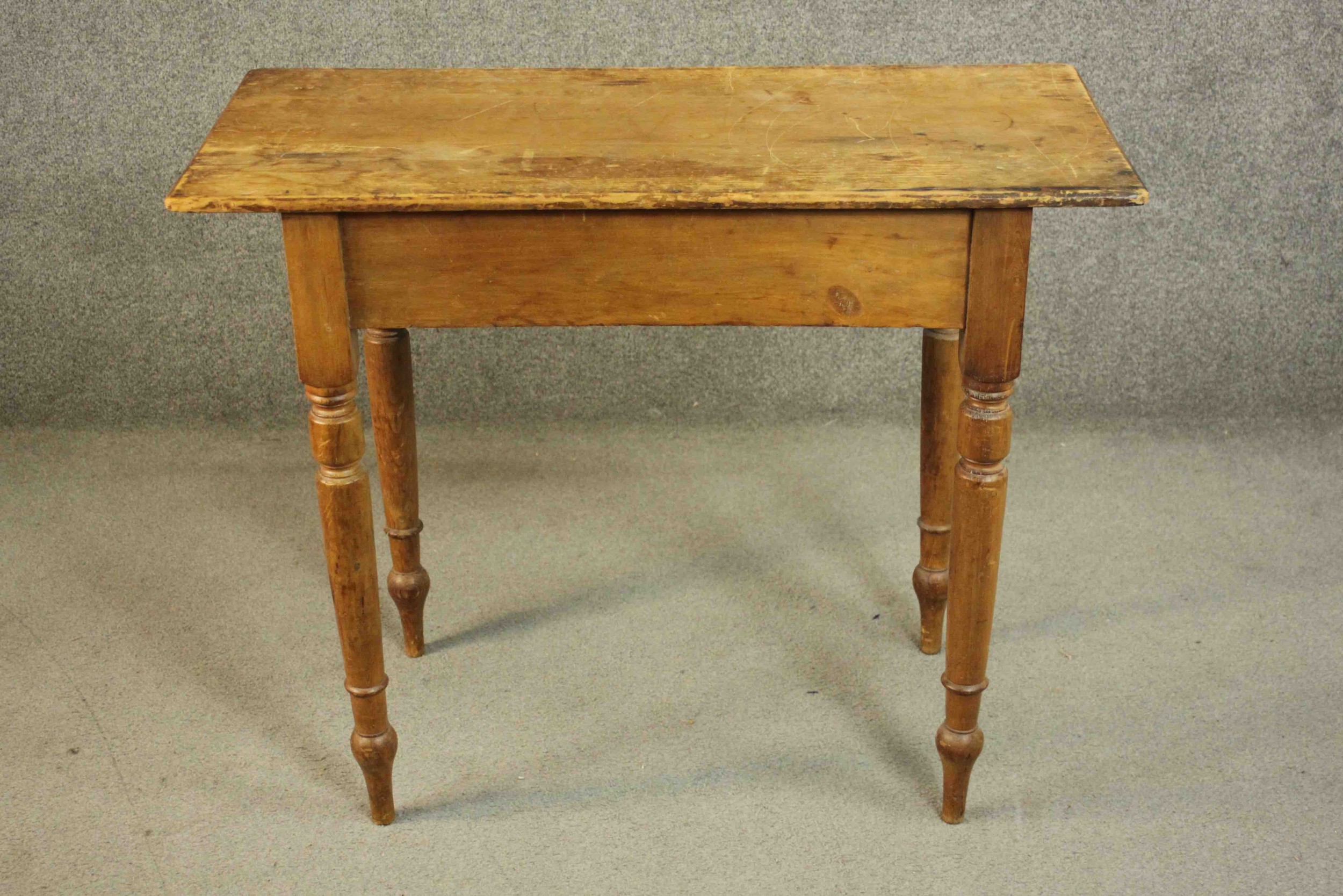 A Victorian pine side table, of rectangular form with turned legs. H.73 W.91 D.43cm.