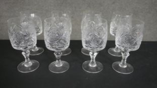 A set of eight hand cut crystal wine glasses. H.18 W.8cm.