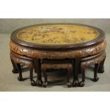 A 20th century Indonesian hardwood coffee table, the oval top ornately carved with a variety of