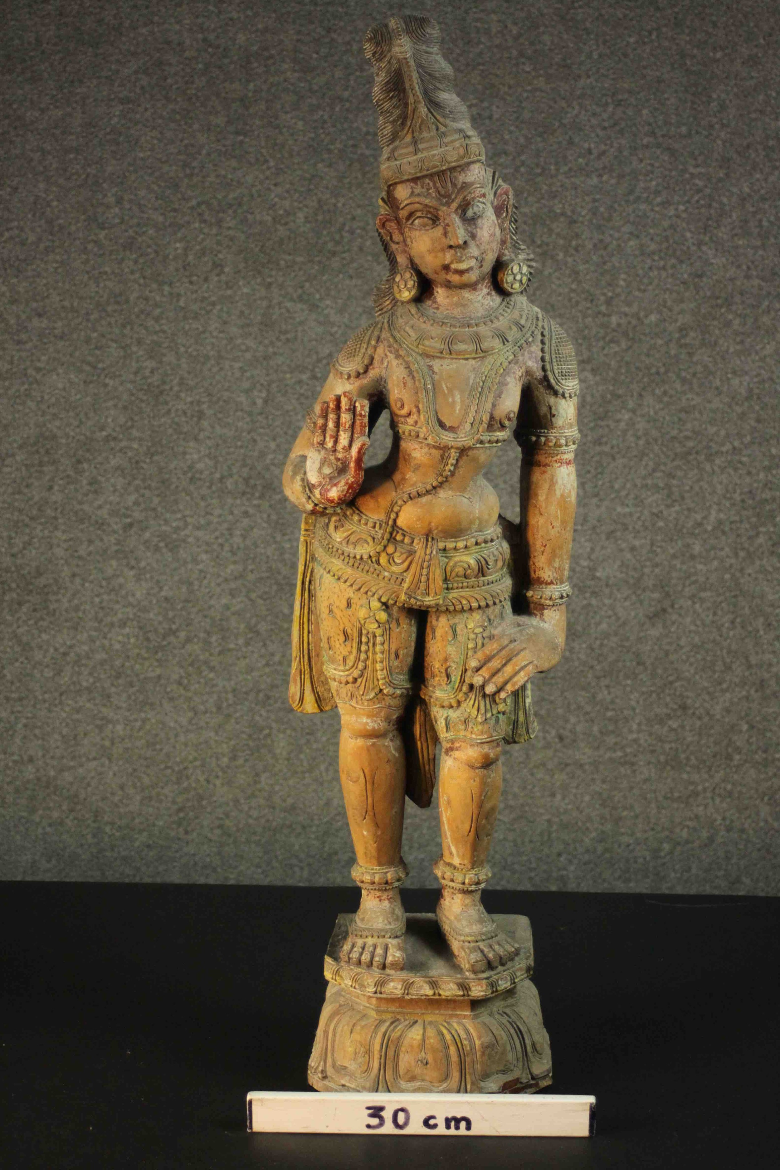 A large carved and painted 19th century Oriental statue of a deity standing on a lotus form base. - Image 2 of 10