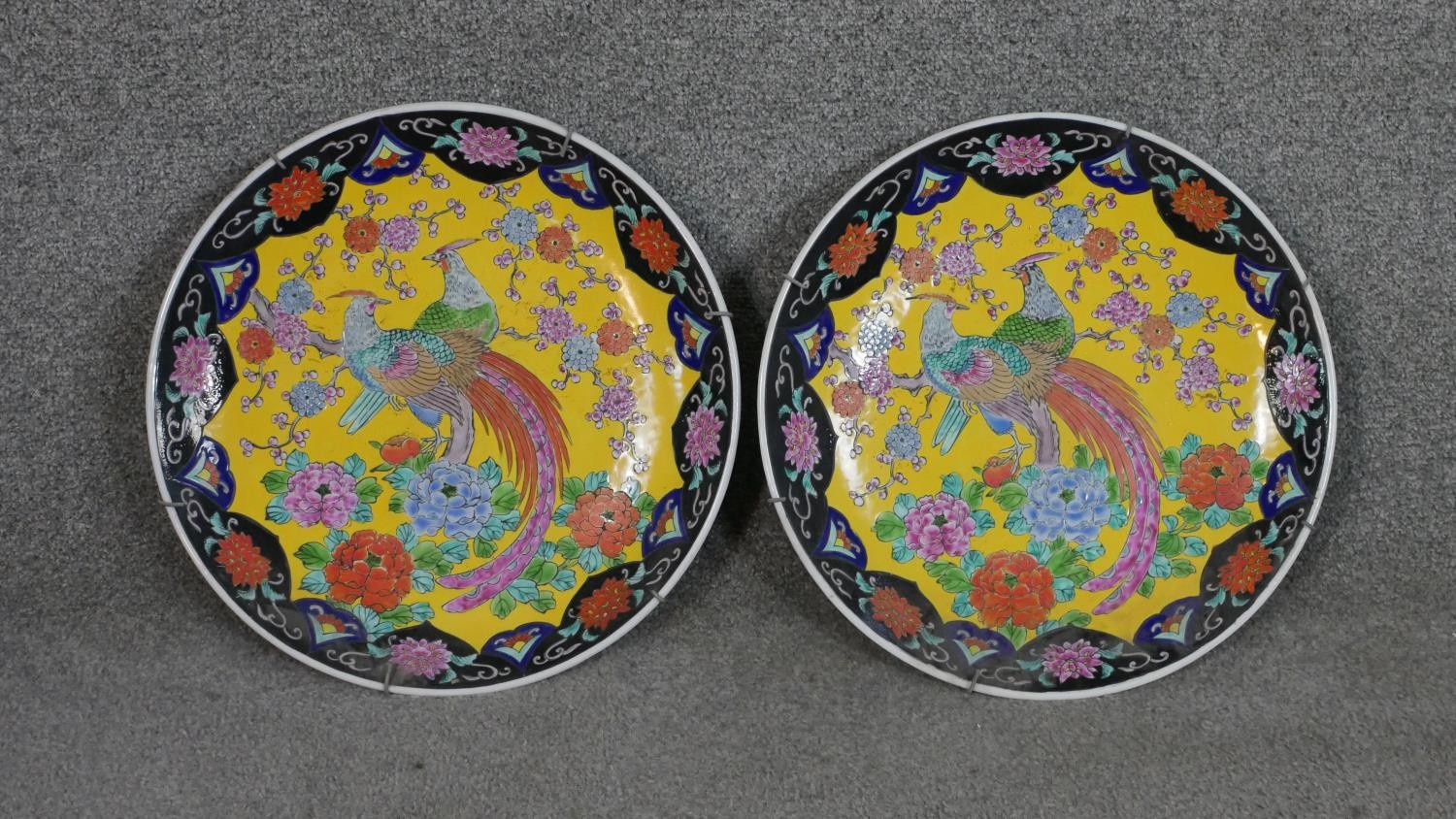 A pair of 20th century Chinese Famille Rose chargers with pheasant among flowers design on yellow - Image 2 of 5