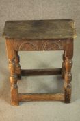 A 17th century and later oak joynt stool, the rectangular seat with a moulded edge over a carved