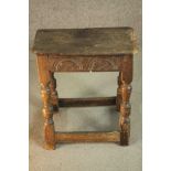 A 17th century and later oak joynt stool, the rectangular seat with a moulded edge over a carved