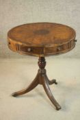 A 19th century mahogany drum table, with a crossbanded and quarter veneered top over four short