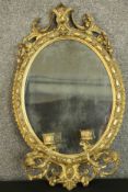 A 19th century French girandole mirror, of oval form, the mirror plate within a moulded acanthus