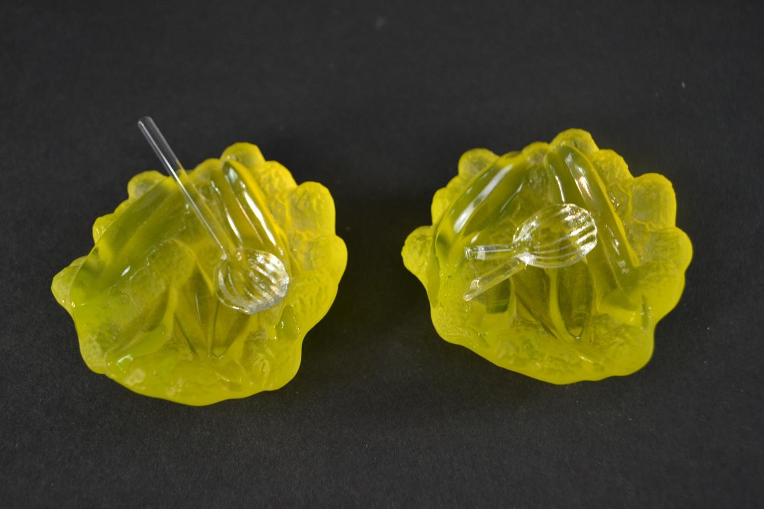 A boxed pair of Daum mini 'Mimosa' design uranium glass salts with glass spoons (one broken). Signed