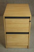 A contemporary limed oak veneered filing cabinet of two drawers. H.72.5 W.48 D.65cm.
