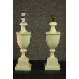 A pair of 20th century classical style white marble urn form lamps, on a square section socle