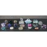 A collection of glass, including seventeen art glass paperweights, a blue opalescent glass basket