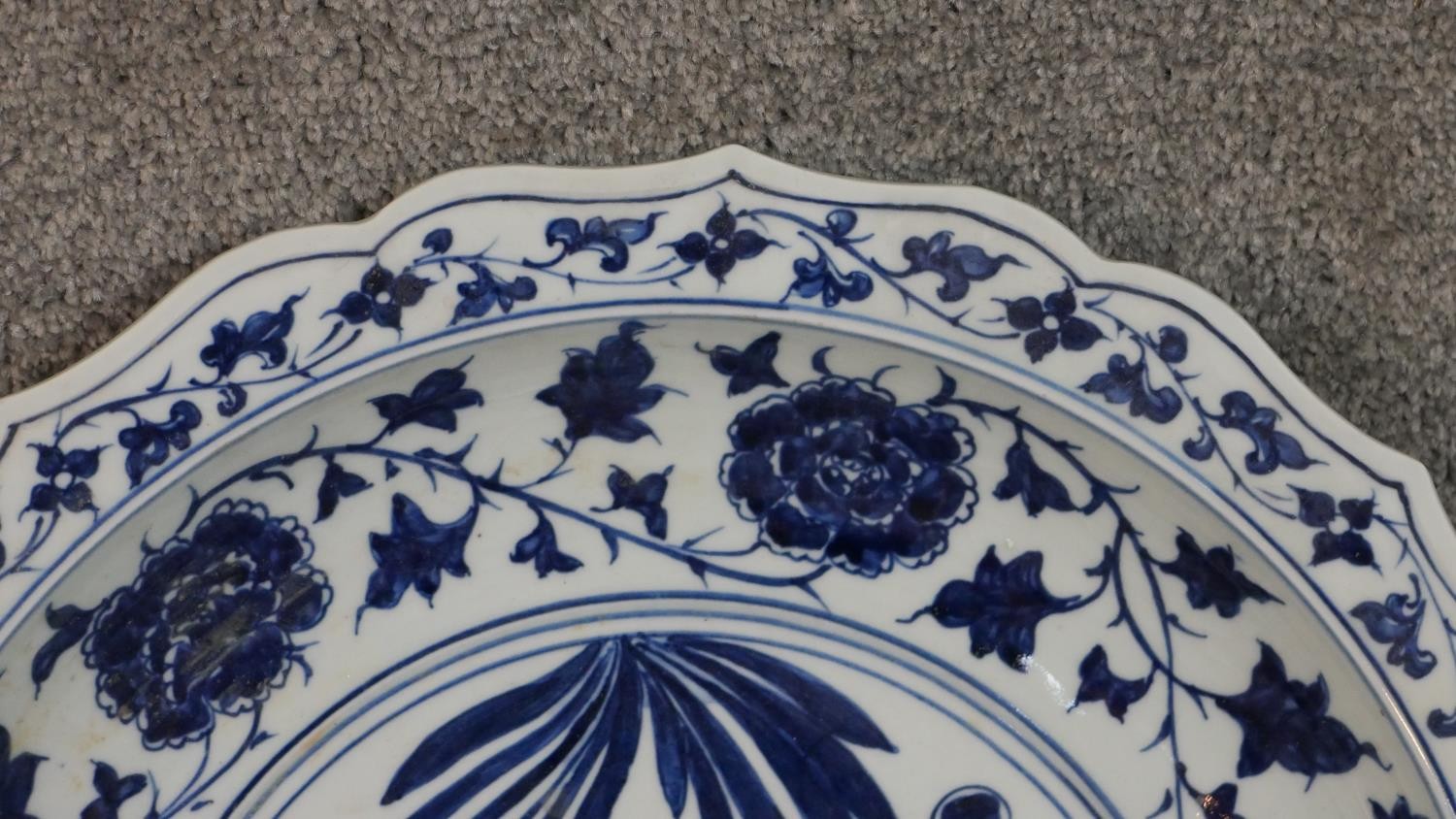 A large 19th century Chinese blue and white porcelain charger, painted with a central fish and - Image 3 of 6