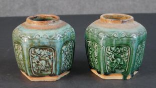 A pair of Chinese green glazed ginger jars with raised character and fruit design. H.13 W.13cm