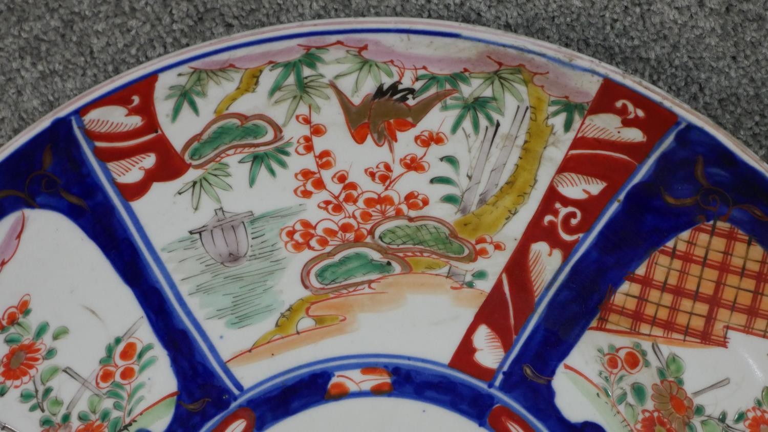 A large 19th century Japanese Imari charger with panels depicting flowers and birds on a dark blue - Image 3 of 4