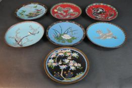 A collection of seven Meji Period Japanese cloisonné plates. Two with a dragon design on red