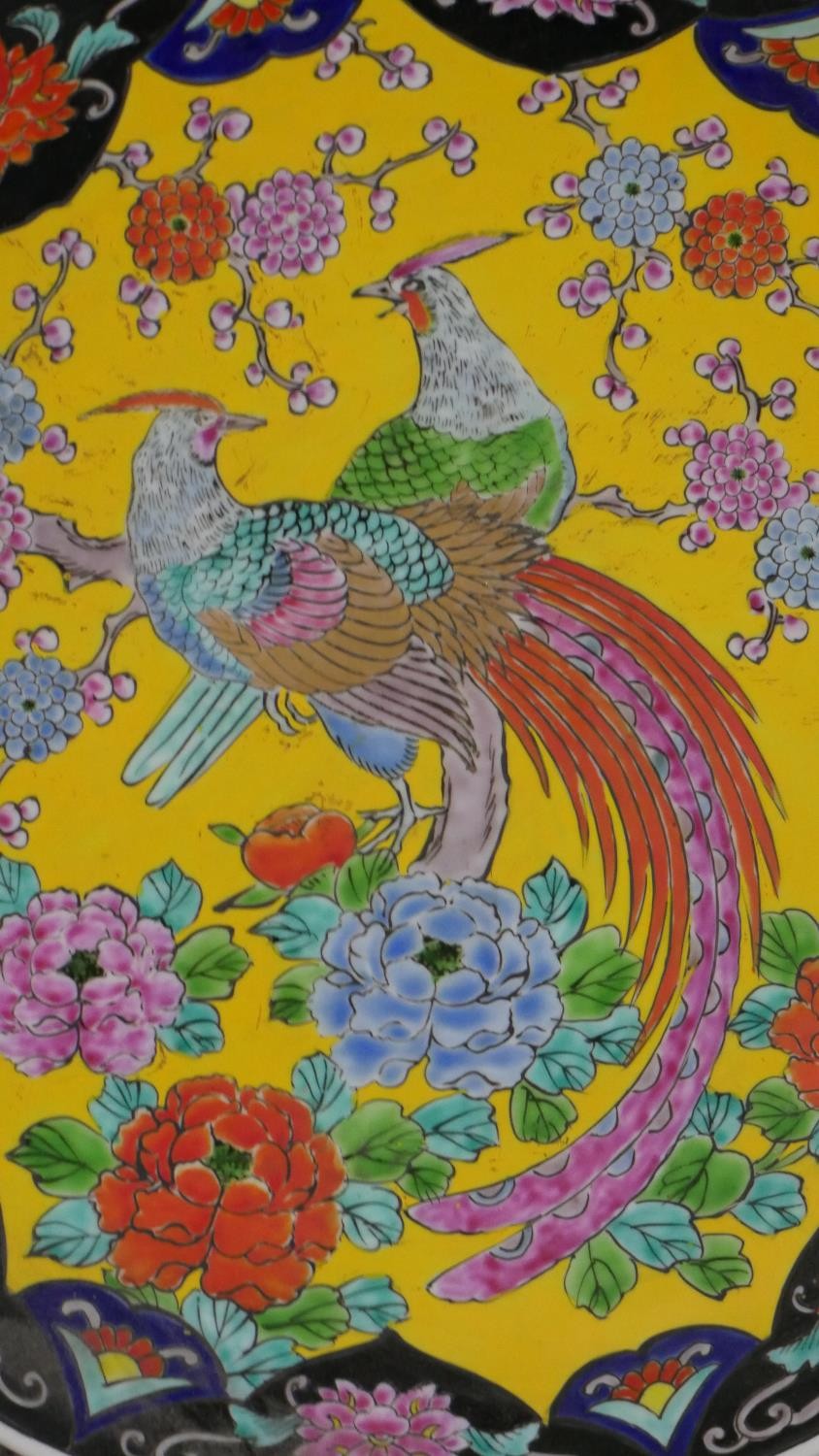 A pair of 20th century Chinese Famille Rose chargers with pheasant among flowers design on yellow - Image 3 of 5