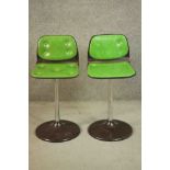 A pair of vintage bar stools in buttoned lime vinyl.