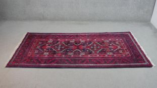 A hand made midnight ground Persian Meshed rug. L.217 W.100cm