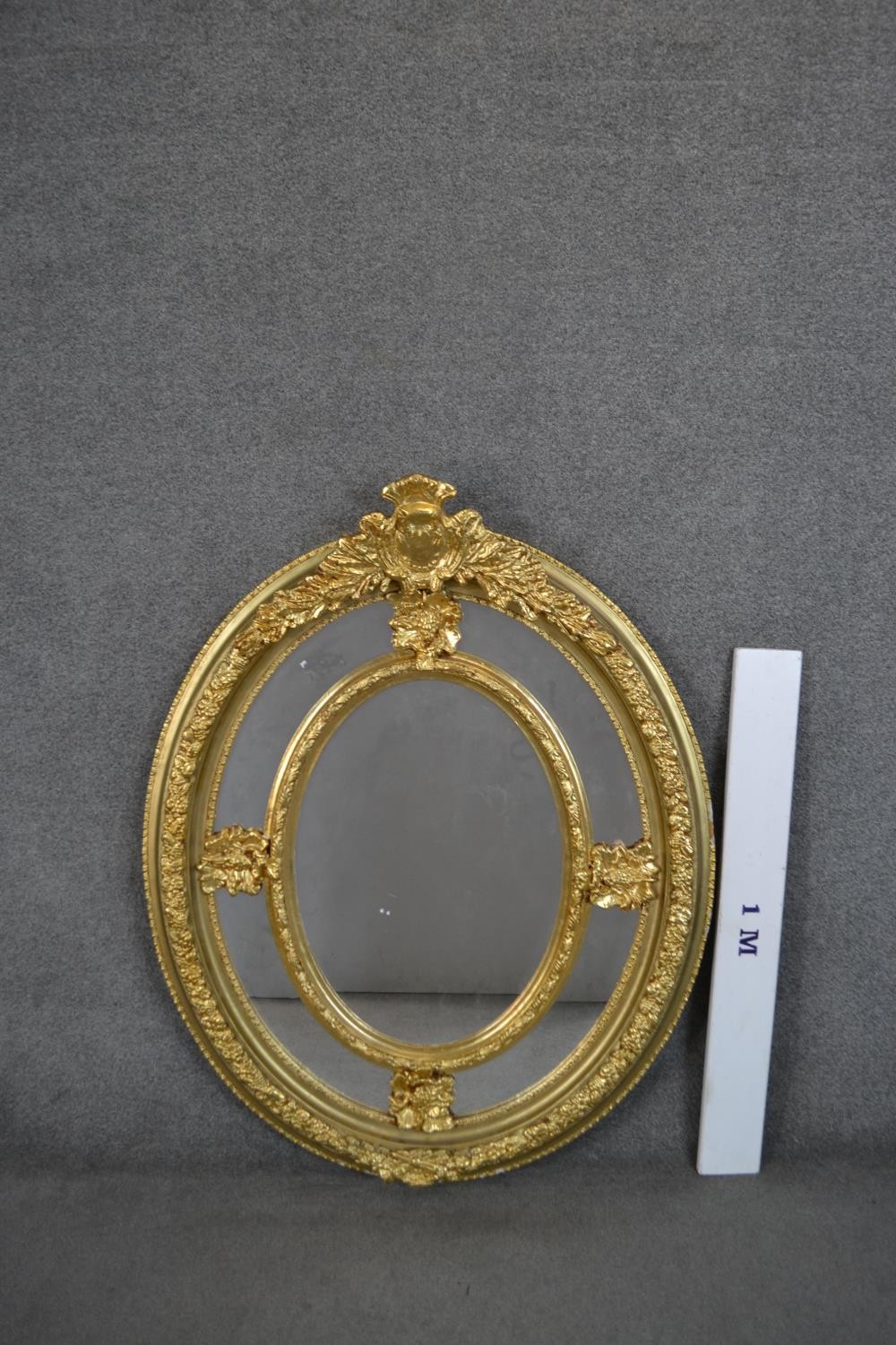 A Victorian gilt framed oval mirror, with a sectional mirror plate in an ornately moulded frame with - Image 2 of 5