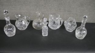 A collection of seven pieces of cut crystal, including a pair of oil and vinegar bottles with