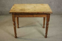 A small Victorian pine kitchen table, of rectangular form with an end drawers on turned legs. H.73