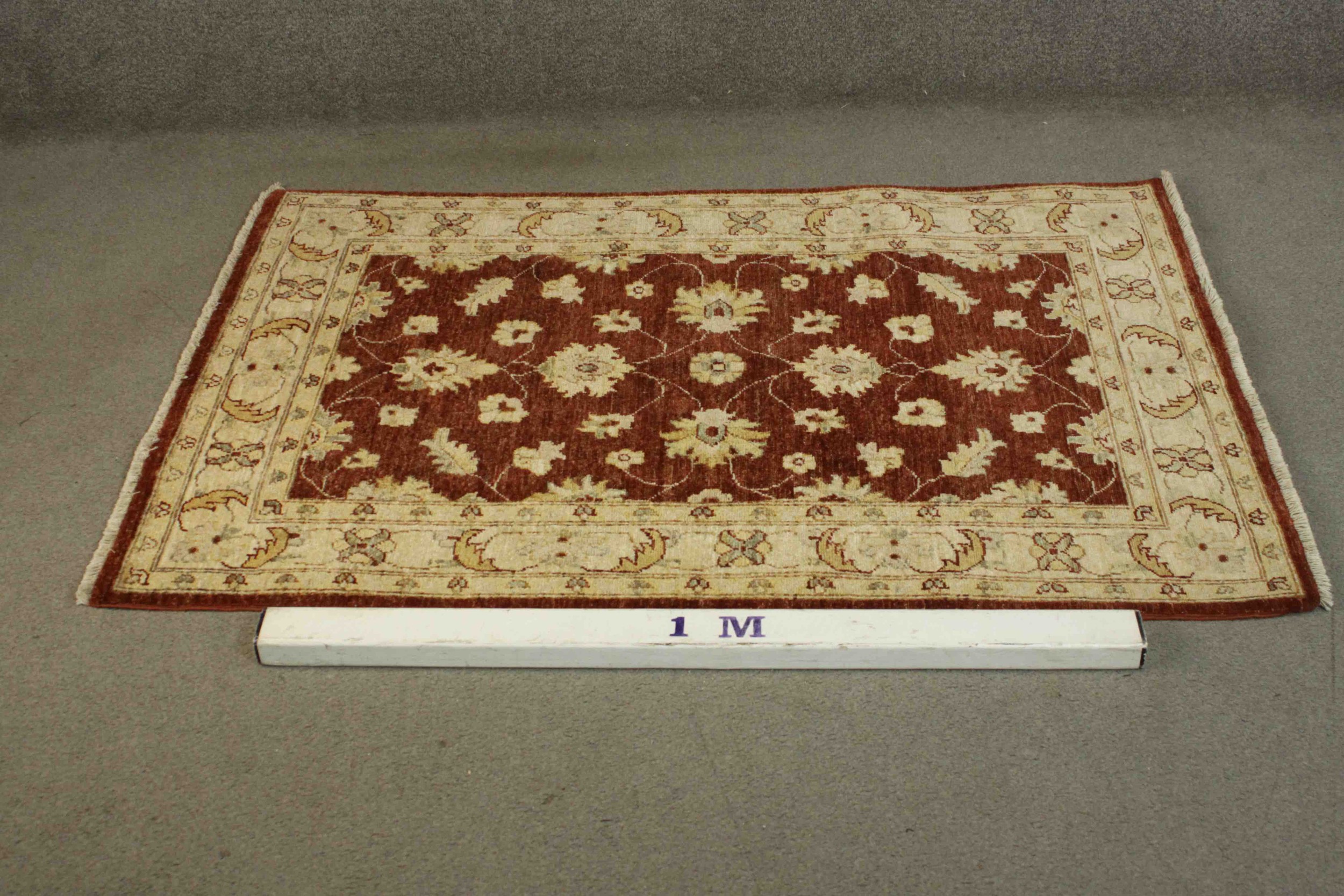 A Ziegler style rug with repeating foliate motifs on a burgundy field within serrated palm - Image 2 of 5